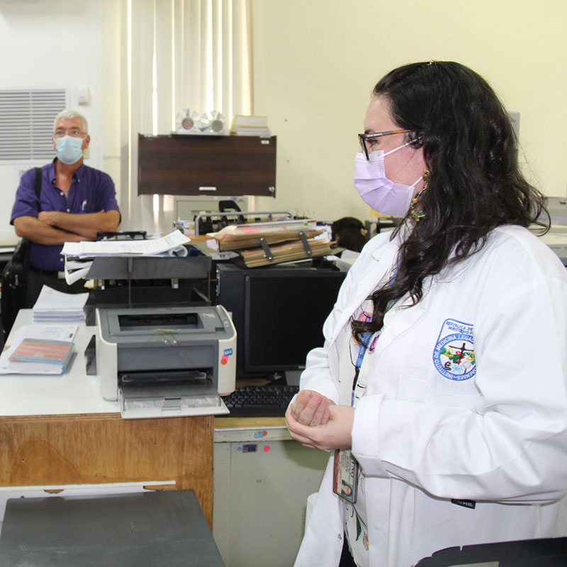 a medical examiner leads a tour of morgue facilities